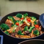 Kolorowe pieczone warzywa i mięso w niebieskim naczyniu żaroodpornym